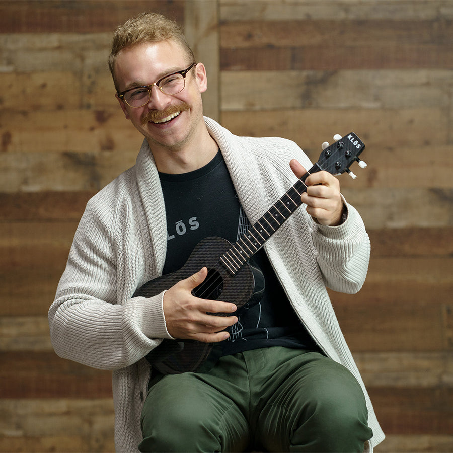 KLŌS CEO Adam Klosoviak plays the concert ukulele 