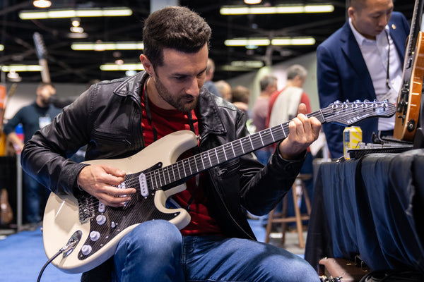Playing the KLŌS F-Series neck at NAMM 