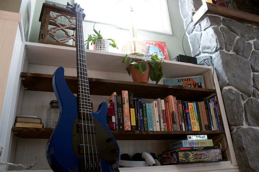 A look at the apollo bass resting next to a bookshelf in a home 
